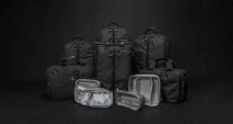 Gura Gear camera backpacks, bags and Et Cetera cases grouped on a black background