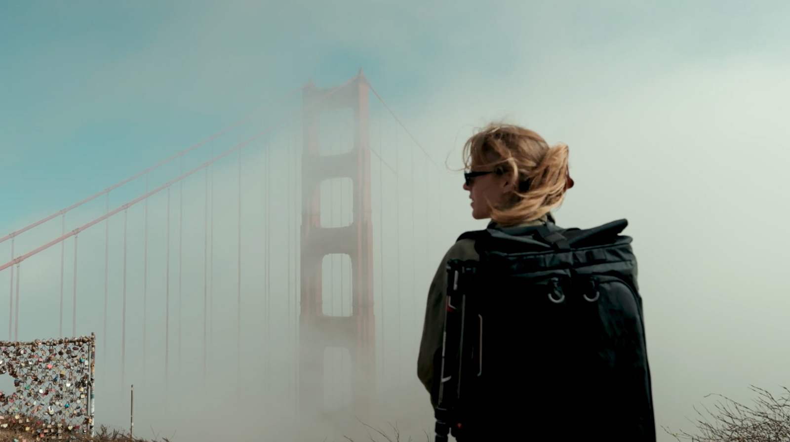 Photographer with a Gura Gear Kiboko camera backpack and tripod at the Golden Gate Bridge in the fog, San Francisco